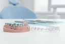 Night guard beside partial denture on dental model