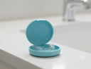 Clear aligners in case on bathroom counter for teeth straightening