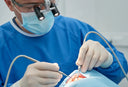 Dentist performing gum surgery to treat periodontal disease