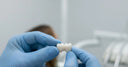 Dentist presenting a new dental crown before placement