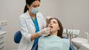 Orthodontist checking retainer fit and tongue health