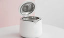 Open ultrasonic cleaner with water-filled tank on clean background