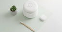 Eco-friendly flat lay with ultrasonic cleaner, bamboo toothbrush, and retainer case