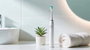 electric toothbrush on modern bathroom counter with soft lighting.