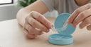 Person placing a transparent aligner into its protective case
