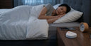 Busy adult wearing clear aligners during sleep for nighttime teeth straightening