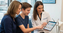 Parent and teenager consulting a dentist about safe whitening options