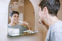 Person brushing teeth with an electric toothbrush