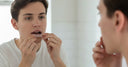 User placing clear aligner onto teeth