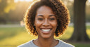Adult smiling with straight teeth after proper retainer use