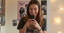 teen taking a progress photo of their teeth in a mirror.