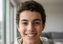 Teen smiling confidently while wearing clear aligners