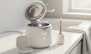 Ultrasonic Clearner, tooth brush and a clear aligner placed on a counter top.