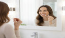 Woman using clear aligners comfortably at home.