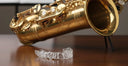 Clear aligners next to a saxophone