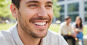 Adult showing NewSmile clear aligners in modern dental office