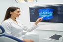 Dentist explaining how clear aligners move teeth using 3D scan.