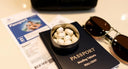 Travel tin of mouthwash tablets with passport and boarding pass