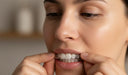 Person removing clear aligners carefully to troubleshoot fit issues.