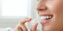 “NewSmile clear retainer being worn to protect teeth and maintain proper alignment.”