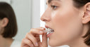 Patient inserting clear aligner tray for at-home teeth straightening