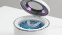 Aligner being cleaned inside an ultrasonic cleaner